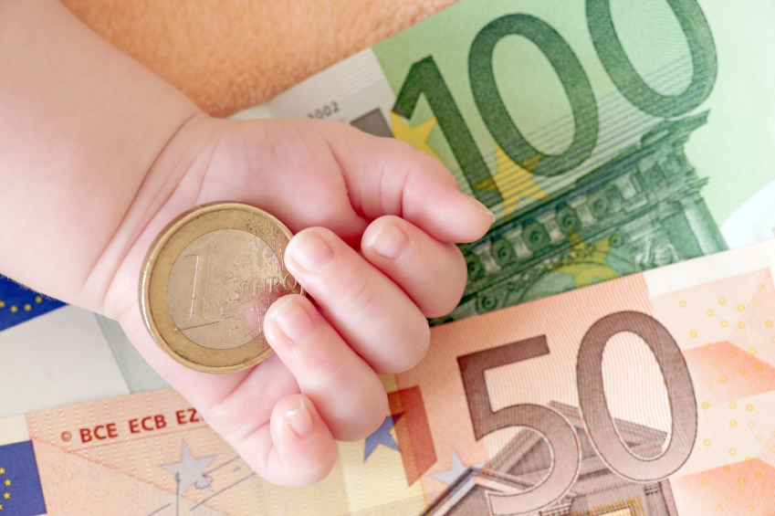 hand of a baby with euro banknotes